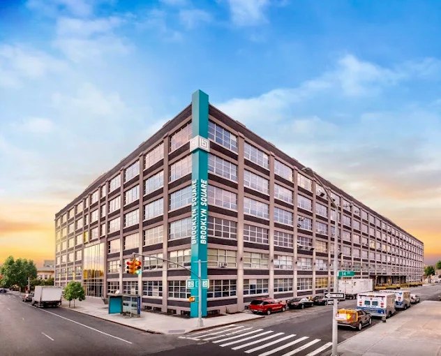 The Brooklyn Square building, a large brick and glass loft building on a Brooklyn street corner